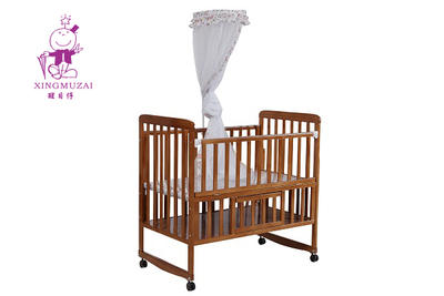 Wooden baby cot with mosquito net